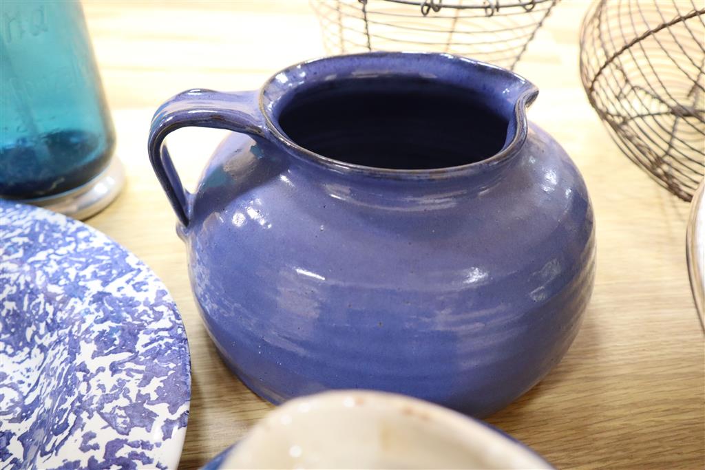 A collection of kitchenwares including a large ironstone jug, 26cm, spongeware bowls, platter, enamel cafeterie, storage jars, cake sta